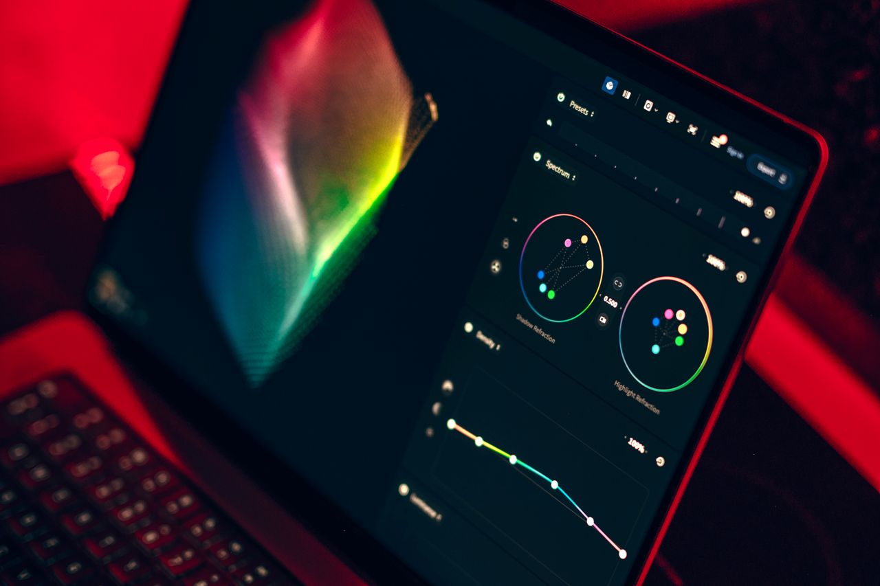 services-03 A close-up shot of a laptop displaying a color grading dashboard with vibrant colors.