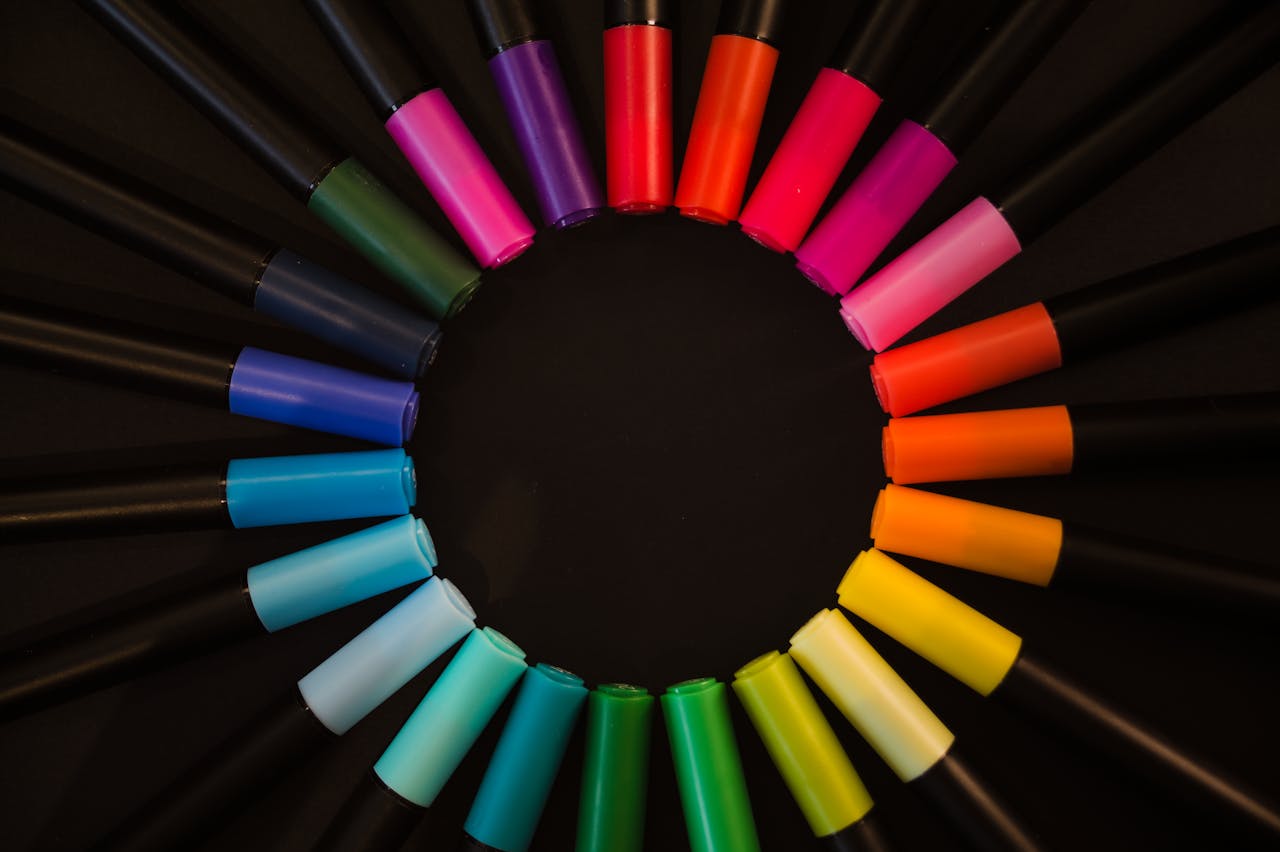 services-01 Vibrant markers arranged in a circular pattern on a black backdrop.